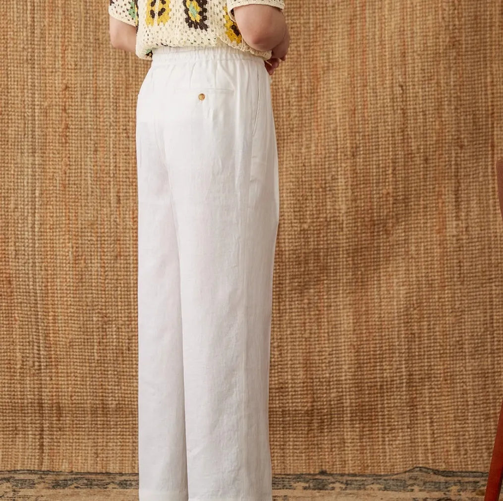 Women's loose fit high waist linen trousers in greige colour with straight leg and elasticated waistband.