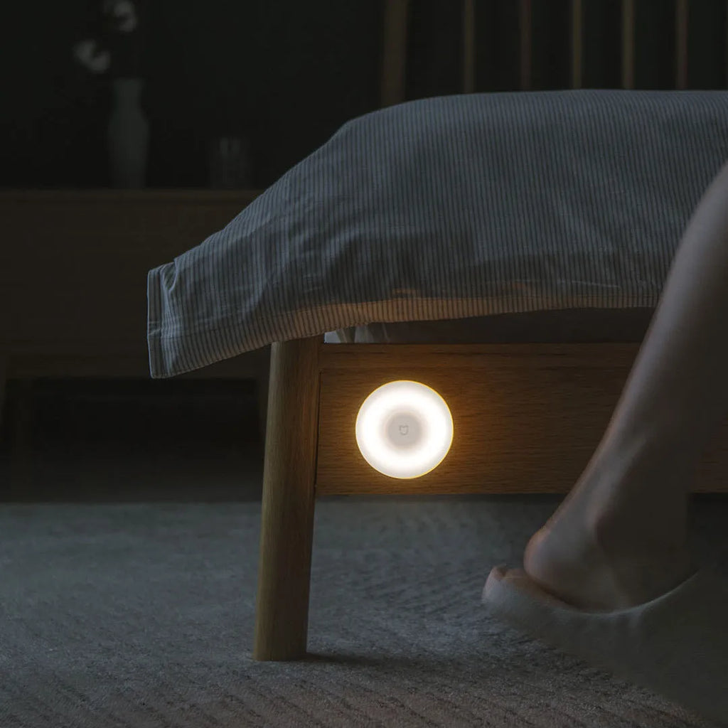 White Mijia Bluetooth bedside lamp with human body induction on a nightstand.