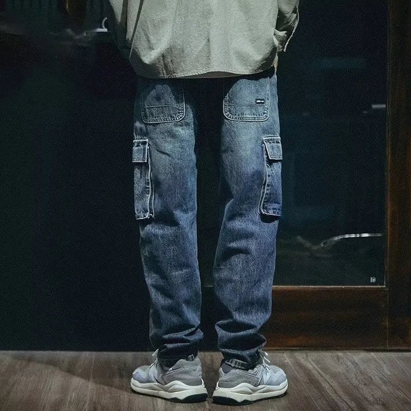 Blue men's loose straight-leg retro-style stretch denim trousers on a plain background.