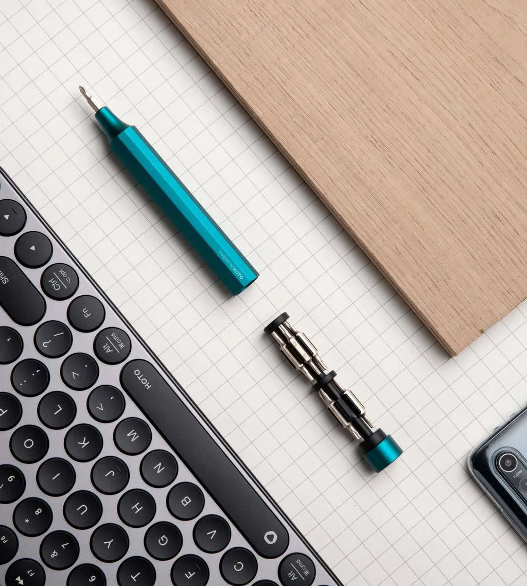 24-in-1 aluminium repair screwdriver set with magnetic bit storage, shown in slate black, for mobile phone and computer disassembly.