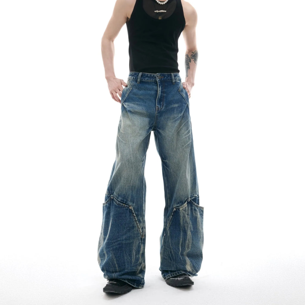 Men's verdant blue jeans with retro washed burst pattern showing curved knife fit and loose styling