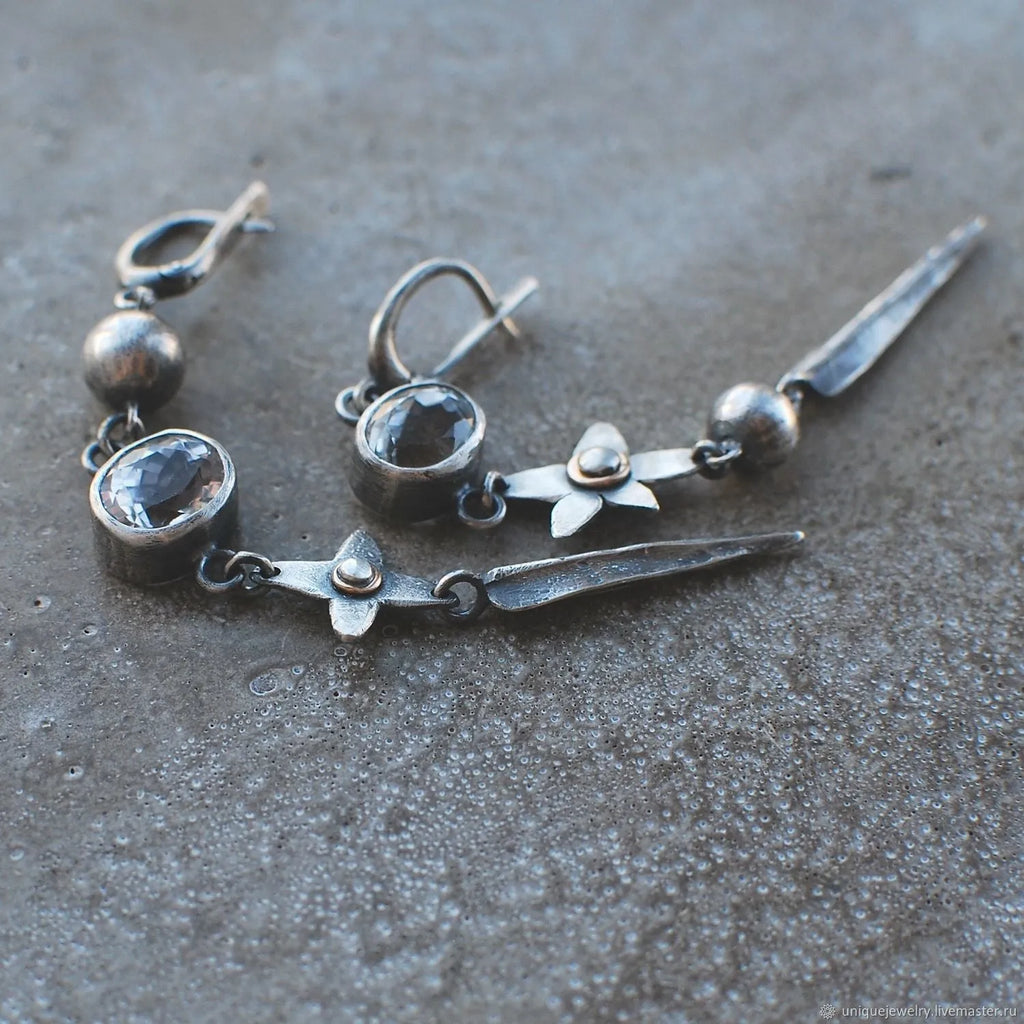 Long geometric XINGX design pendant earrings in antique silver tone with rhinestones.
