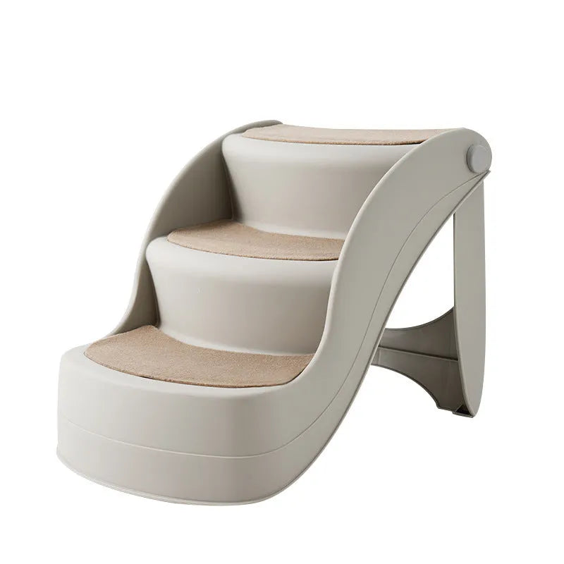 Foldable plastic pet stairs with non-slip surface in beige colour beside a sofa