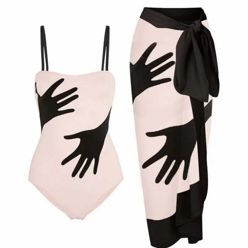 Women's patterned one-piece bikini swimsuit with a separate white tulle skirt laid flat.