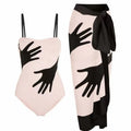 Women's patterned one-piece bikini swimsuit with a separate white tulle skirt laid flat.