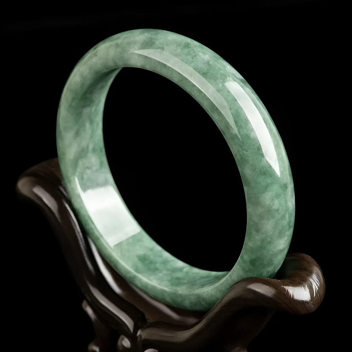 Natural emerald green stone bracelet for women on a wrist, presented with its certificate and gift box.