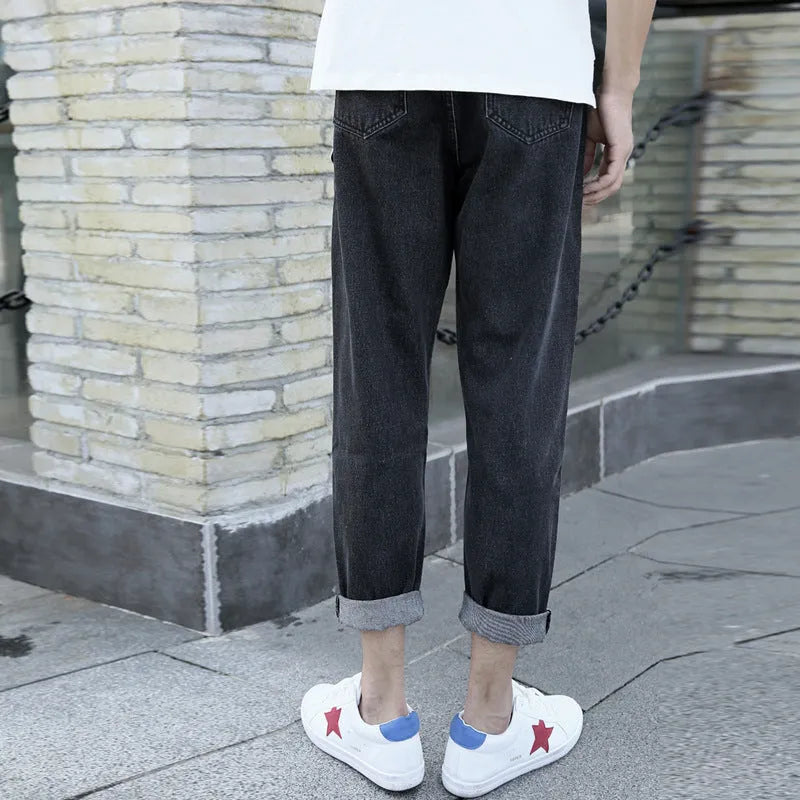 Men's loose straight leg cotton jeans in black, showing relaxed fit and light straight leg opening.
