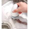White and orange carrot-shaped nylon cleaning brush for kitchen use