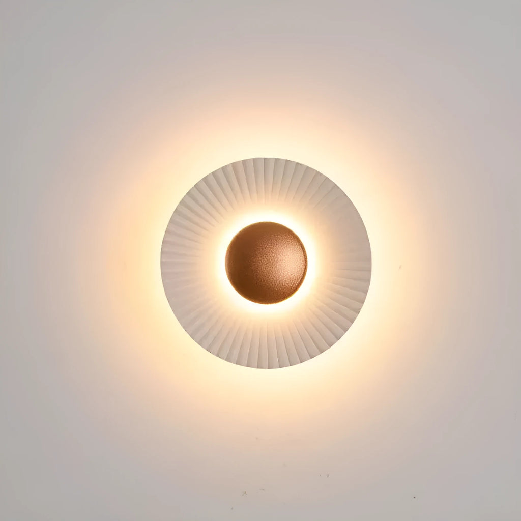 Round aluminium LED wall lamp in outer white and inner gold finish mounted on a wall.