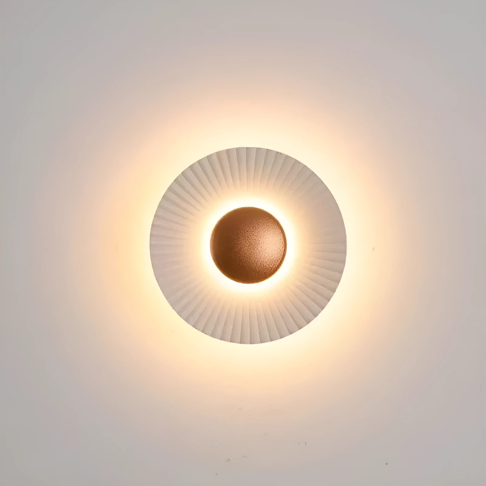 Round aluminium LED wall lamp in outer white and inner gold finish mounted on a wall.