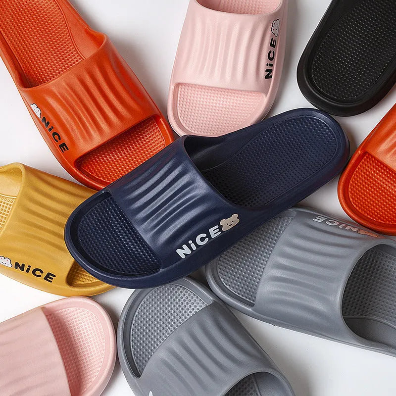 Pair of adult EVA flip flop slippers with a cartoon pattern on a non-slip sole, shown in one of six available colours.