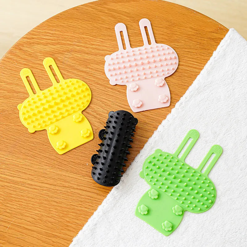 Silicone pet grooming comb with adjustable strap mounted on table leg for cats and dogs