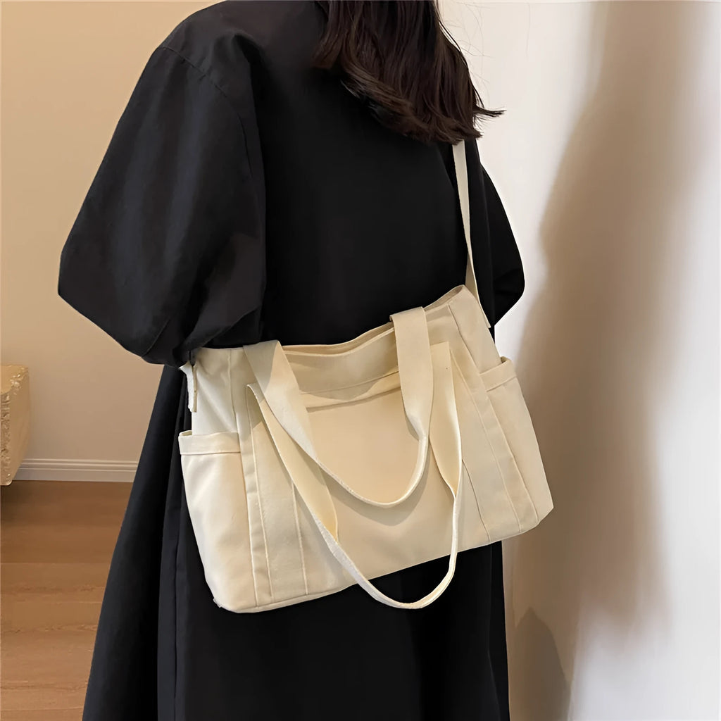 Solid colour polyester tote bag with large capacity and a mobile phone pocket.
