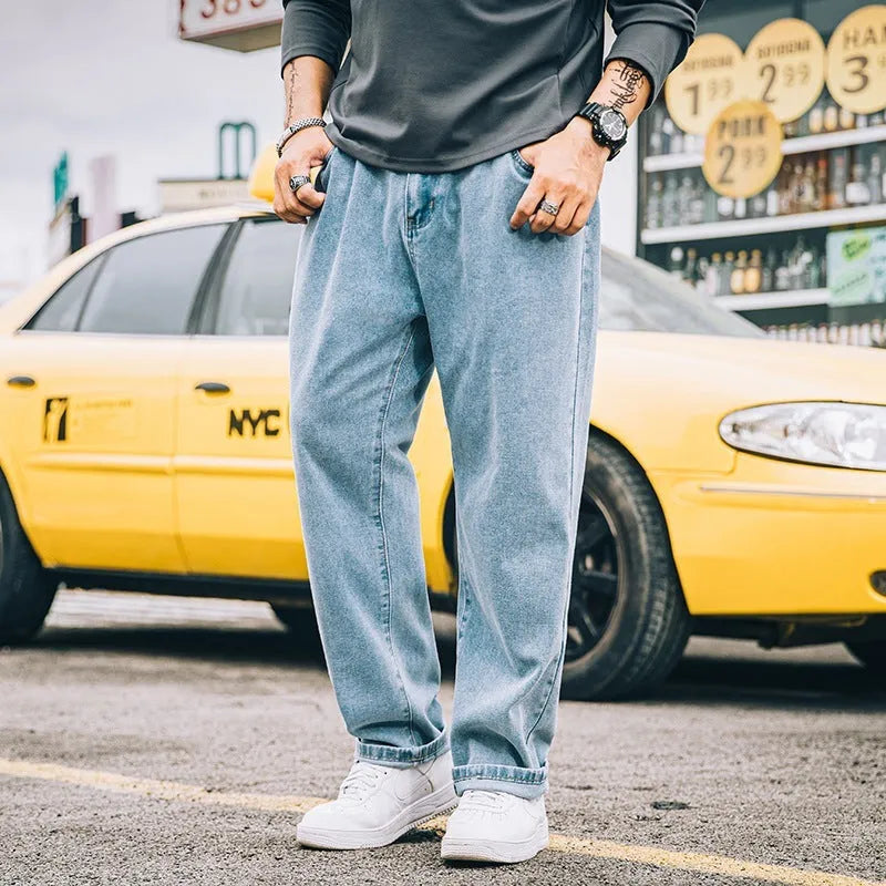 Men's loose straight leg jeans in dark blue cotton denim with a mid-rise waist and zipper fly
