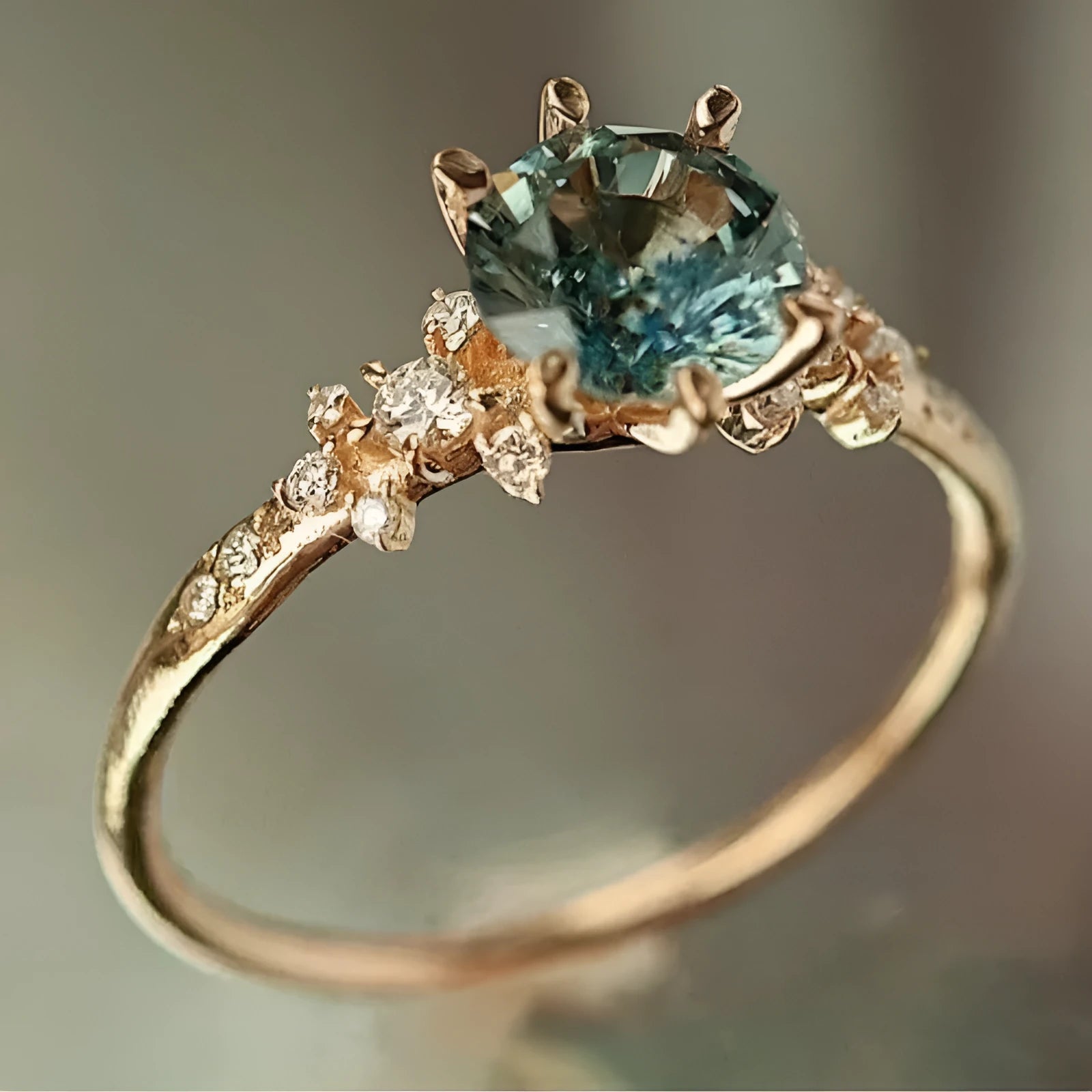 Gold geometric claw ring with micro-set zircon stones and a chamfered square pattern design.