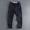 Men's dark blue cotton work trousers with N I buckle belt showing three-dimensional cutting and zip fly fastening
