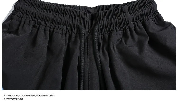 Men's loose-fit quick-dry training shorts in black with elastic waistband and straight-leg cut.