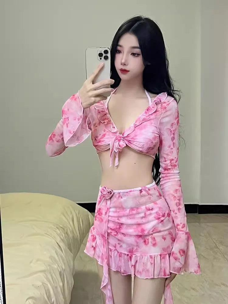 Women's cherry blossom pink floral print bikini swimsuit set on a white background.
