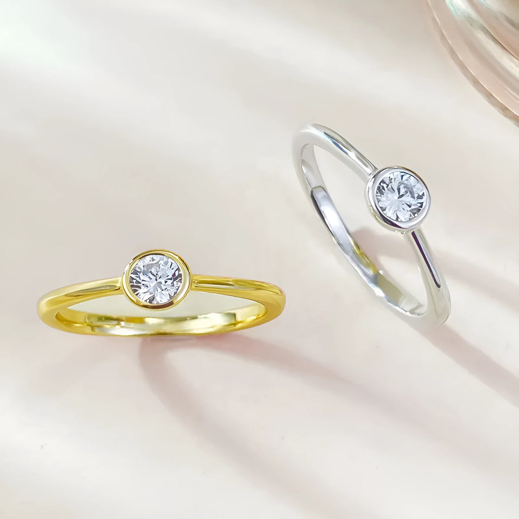 Minimalist silver crown-shaped ring with linear engraving detail in gold or platinum electroplated finish.