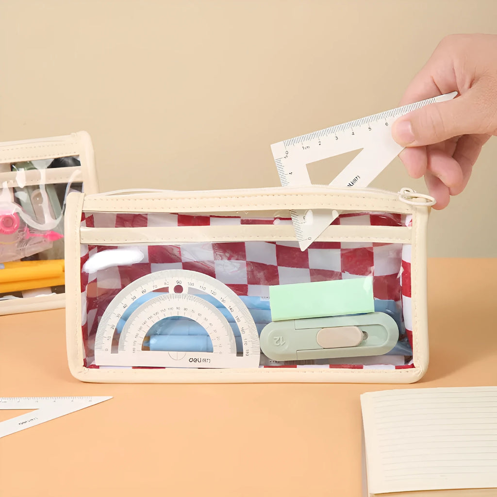 Transparent PVC pencil case with chessboard grid pattern showing pens inside, measuring 21.5cm long
