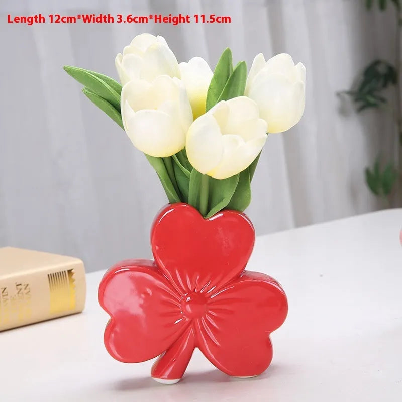 Clover-shaped white porcelain vase in European style on a desktop.