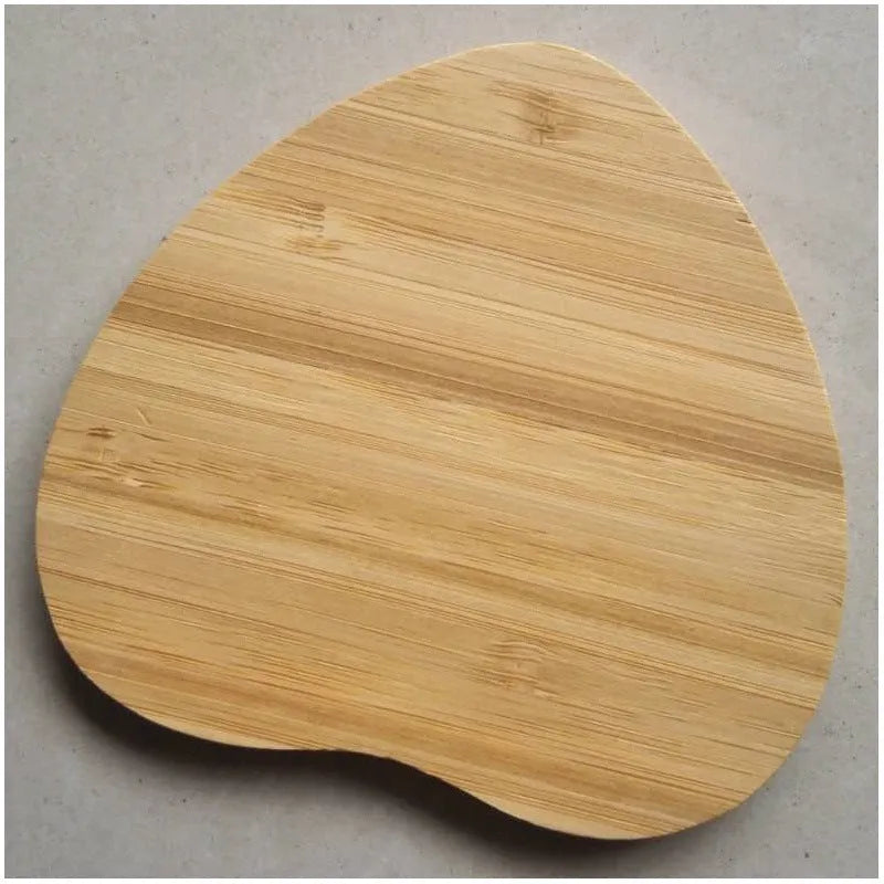 Square brown wooden bamboo 5W Qi wireless charging pad on a table.