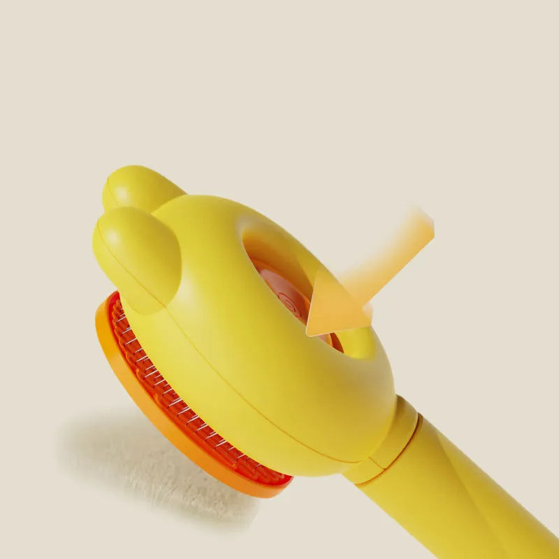 Green self-cleaning pet grooming brush with metal comb and comfort-grip handle on a wooden table.
