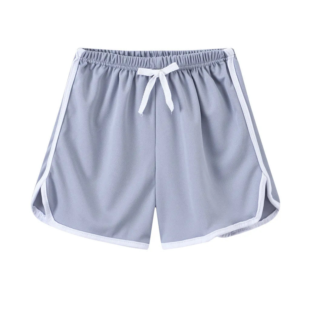 Children's colourful polyester beach shorts showing patterns like leopard print, stripes, and pineapples.