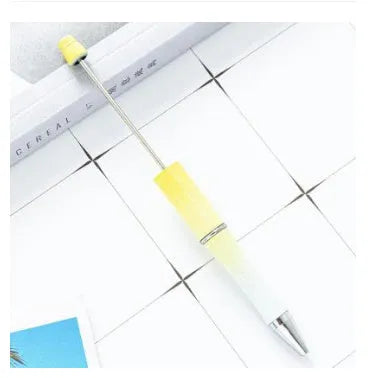 Ballpoint pen with colourful spinning plastic beads on barrel, shown in a gradient purple finish.