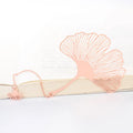Brass electroplated metal bookmark with detailed hollow leaf pendant and rose gold tassel on chain.
