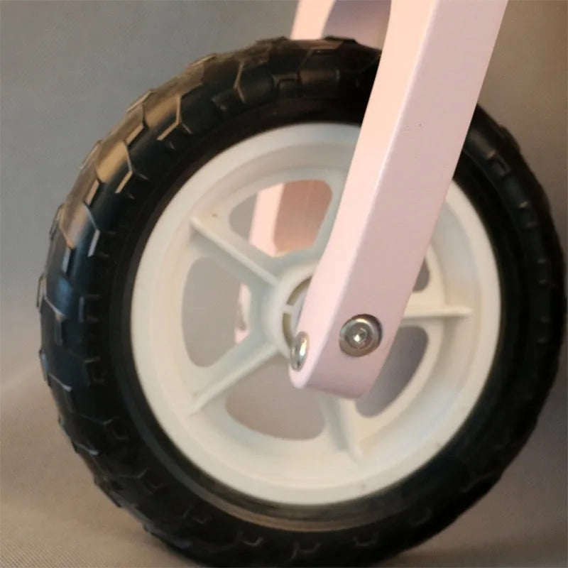 Pink wooden balance scooter for toddlers and children aged 1-6 years.