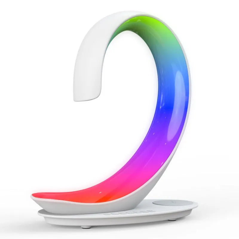 White swan-shaped desktop device with wireless charging pad, Bluetooth speaker, and colourful atmosphere lighting.