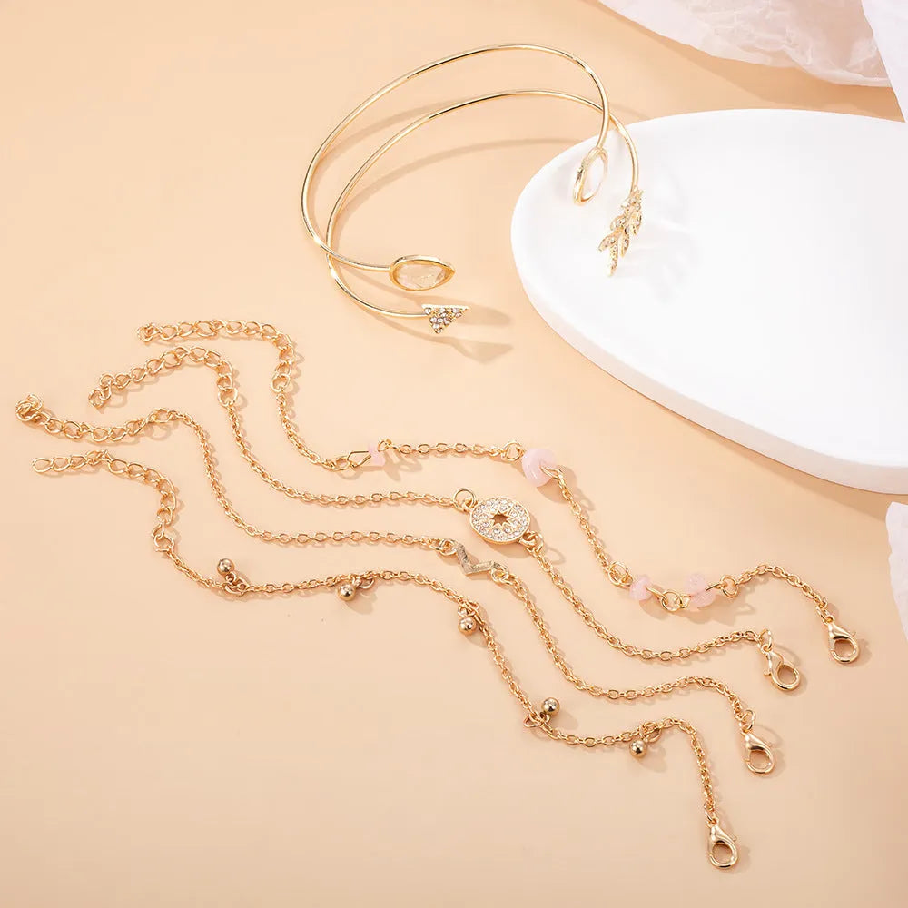 Golden spot finish zinc alloy bracelet set with six pieces featuring arrow, water drop and V-shaped geometric designs