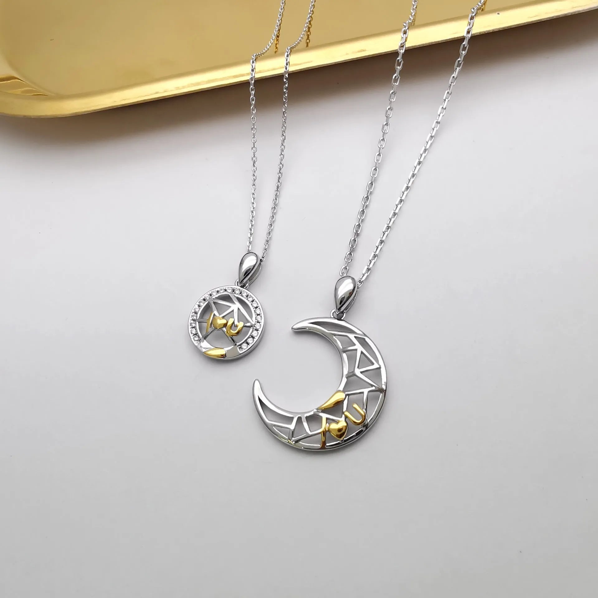 Sun Moon Tooth Couple Necklace showing electroplated copper pendant with cross chain