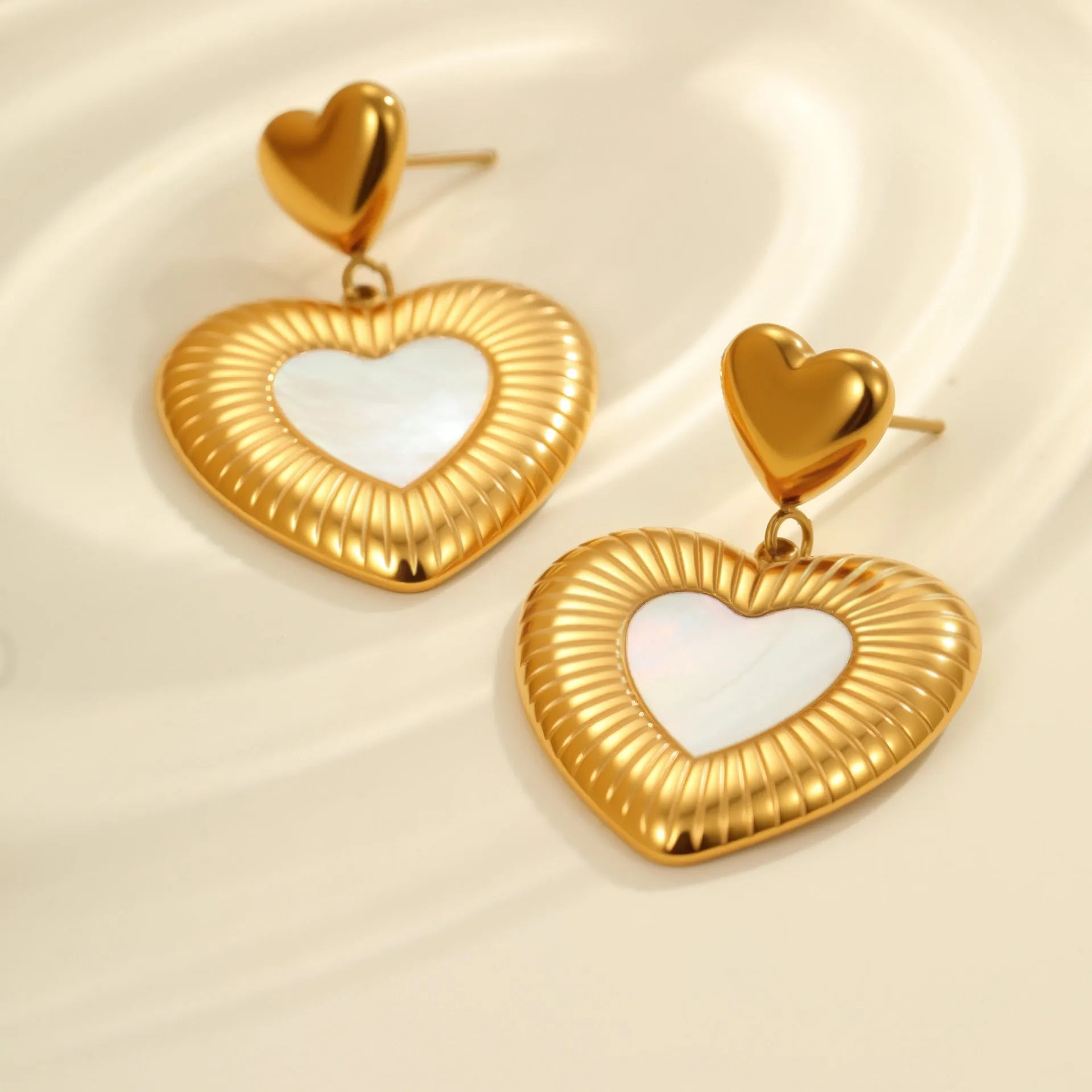 Stainless steel heart-shaped earrings with white fritillary design and 18K gold electroplating finish