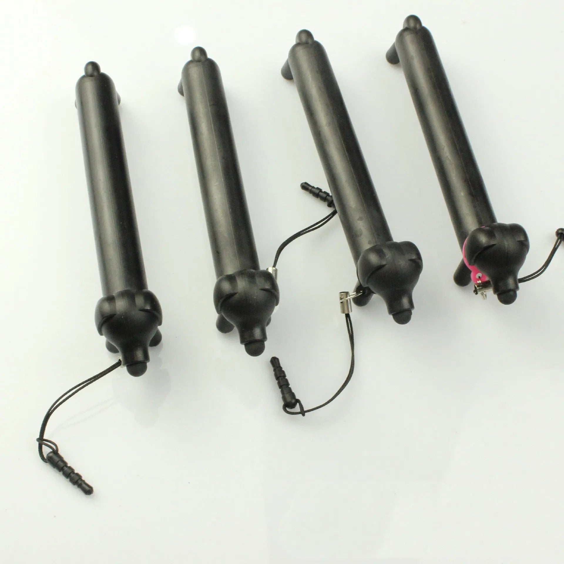Black dog-shaped touch screen stylus showing dual-length design and phone holder function
