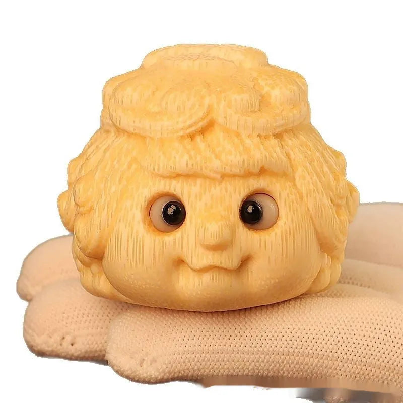 Golden Toad Princess ornament carved from solid bamboo on a wooden surface.