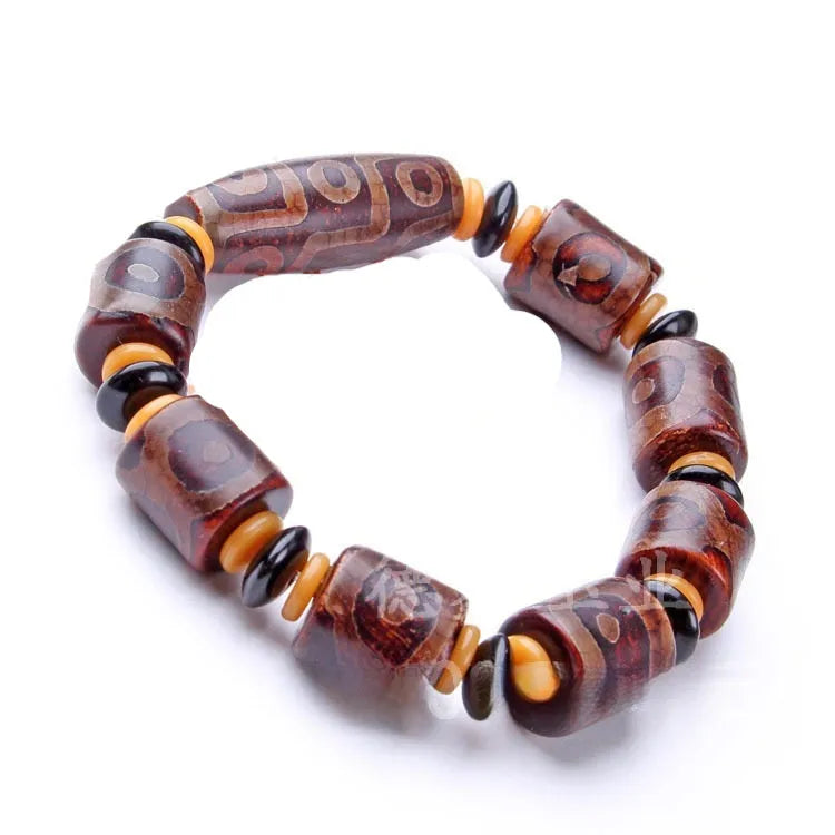 Distressed agate bracelet with traditional Tibetan dzi beads including three-eye and Nine Eyes designs.