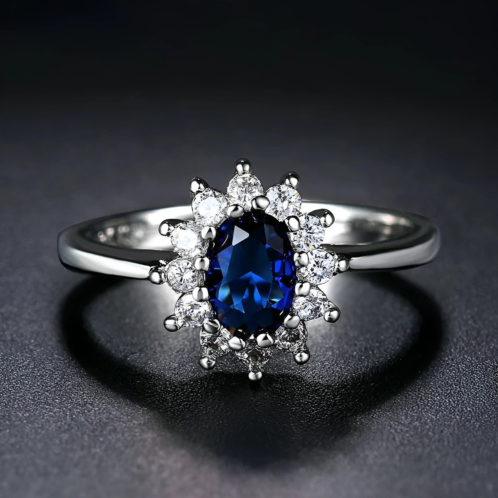 Copper flower-shaped ring with inlaid zirconia available in sapphire blue, green, and pomegranate red colours.