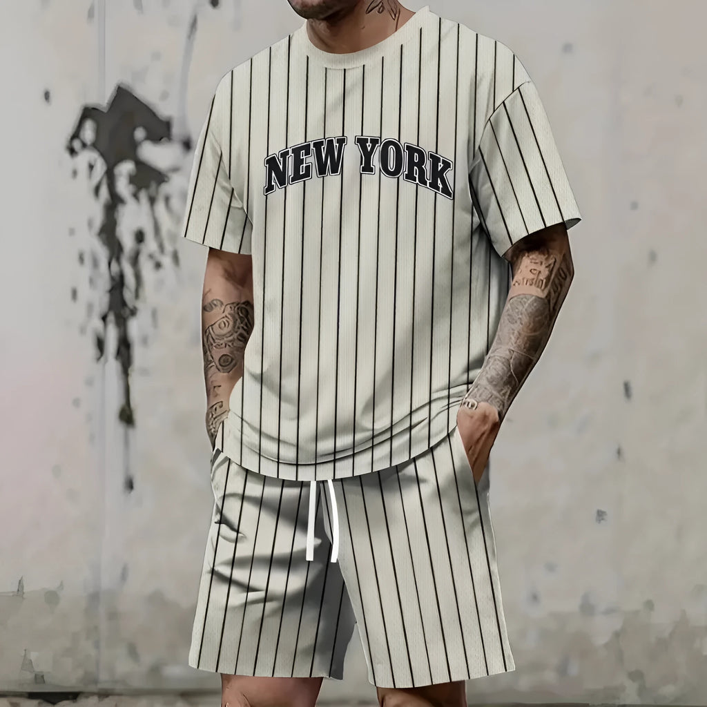 Man wearing a matching 3D printed letter design short sleeve top and shorts in a sportswear setting.