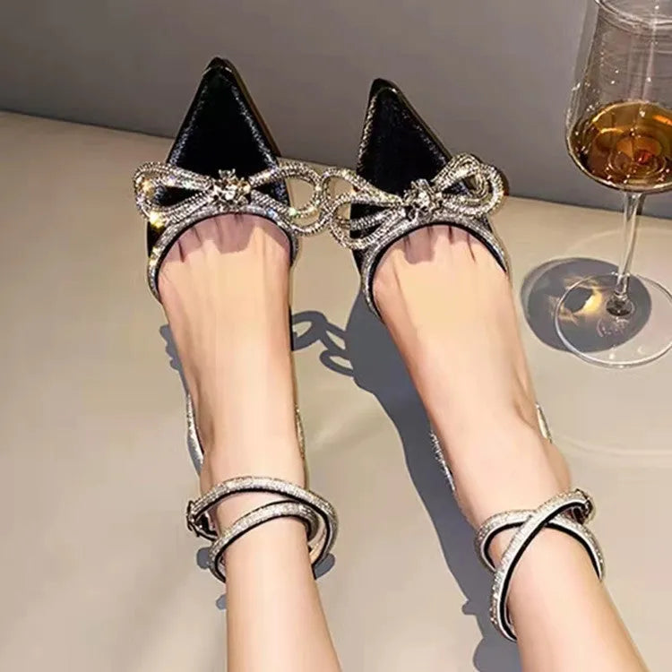Women's black stiletto heel sandals with a pointed toe and an adjustable silk back bandage buckle.
