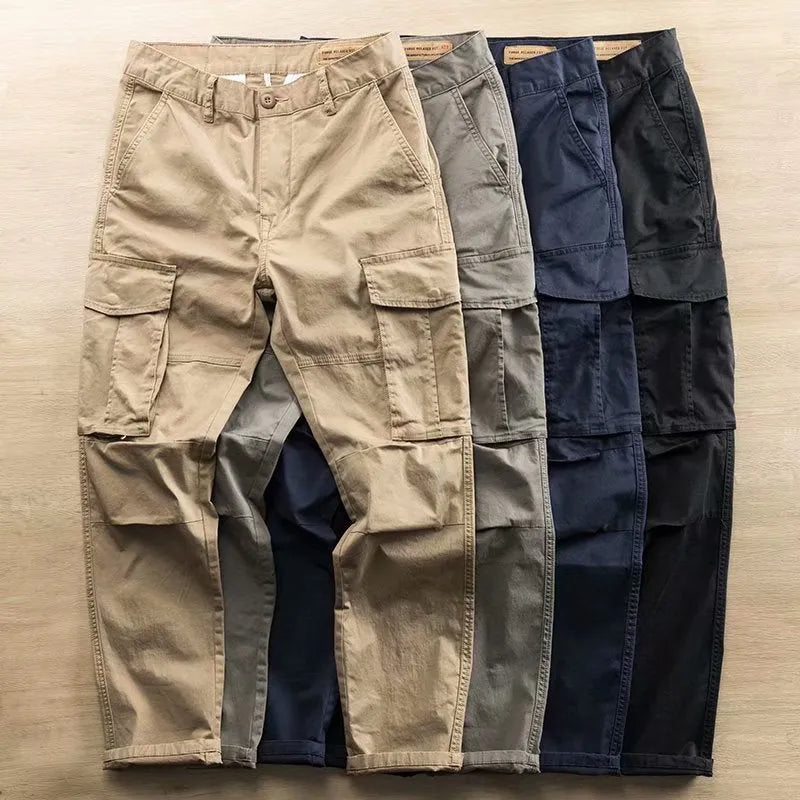 Men's cropped multi-pocket cotton work trousers in khaki, shown on a hanger.