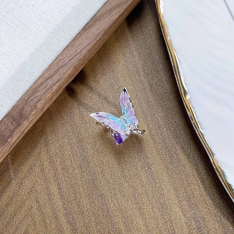 Adjustable copper insect motif ring with textured drip oil finish shown in available colour variations