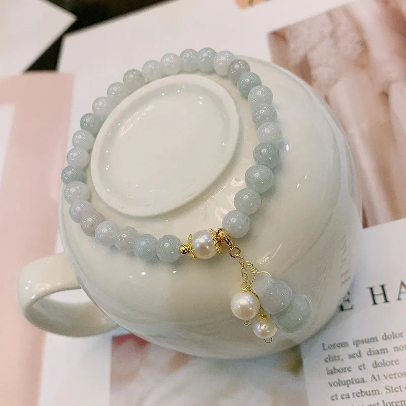 Natural jade bracelet with hand-carved gourd design in Chinese women's style.