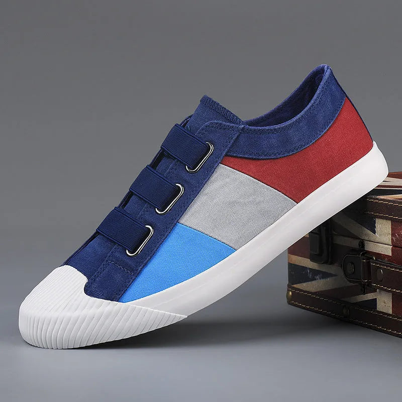 Men's beige canvas low-top sneakers with elastic band closure and a flat rubber sole.