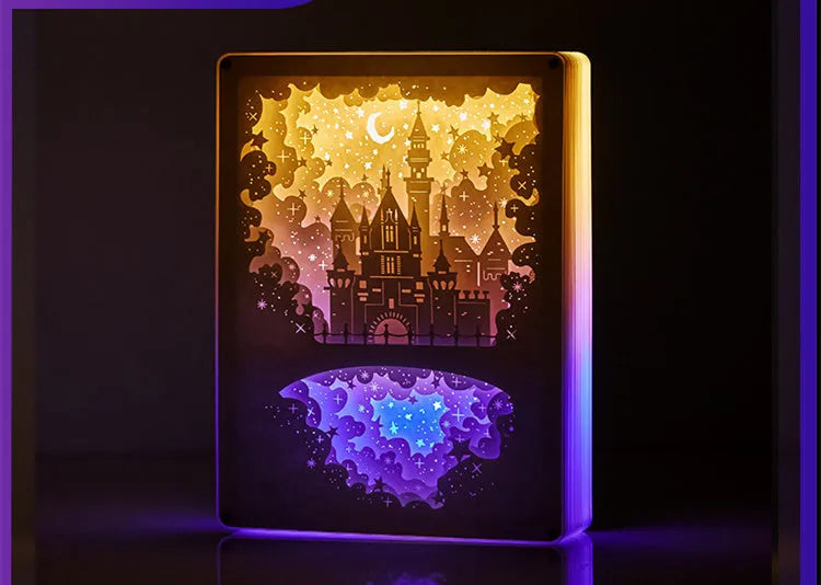 Three-dimensional paper carving USB bedside night light with remote control on wooden table