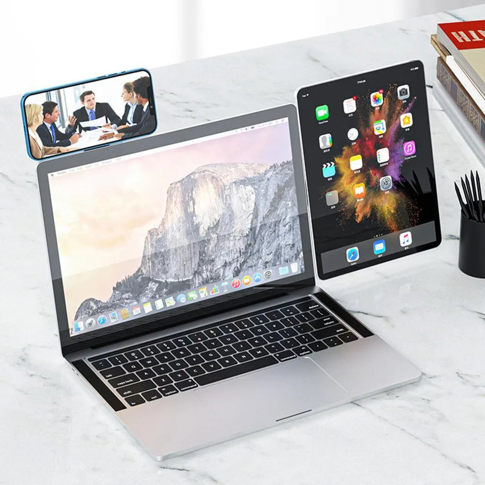 Black aluminium magnetic phone holder clipped to the side of a silver laptop.