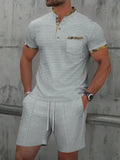 Men's grey cotton blend polo short sleeve suit with matching shorts laid flat