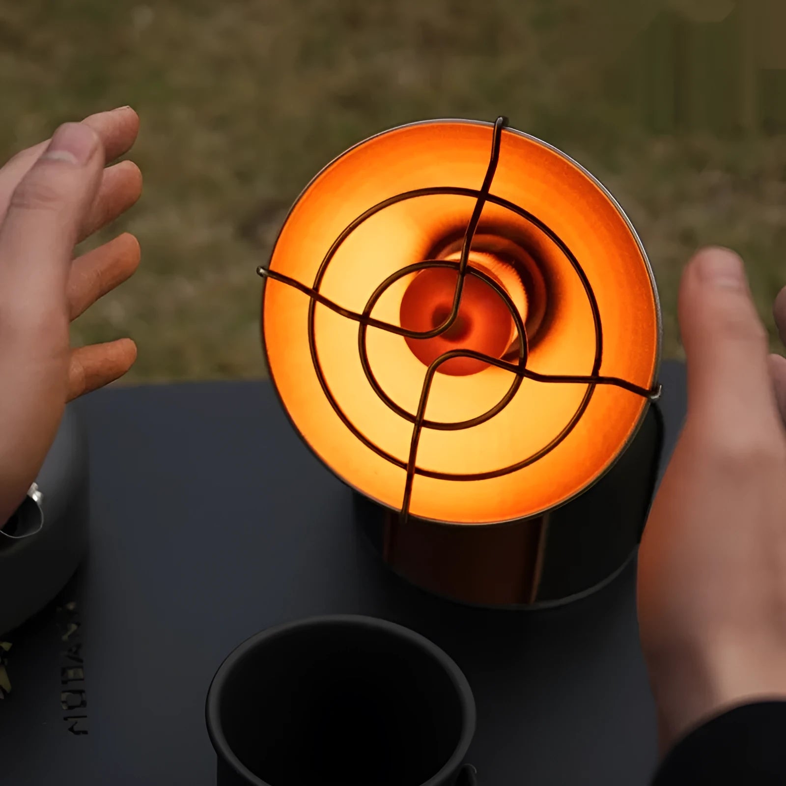 Black and orange mini portable heating stove with stainless steel body and automatic press ignition for camping