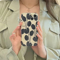 Black silicone iPhone case with tulip design for iPhone 13, 12, 11, X, and 7/8 Plus models